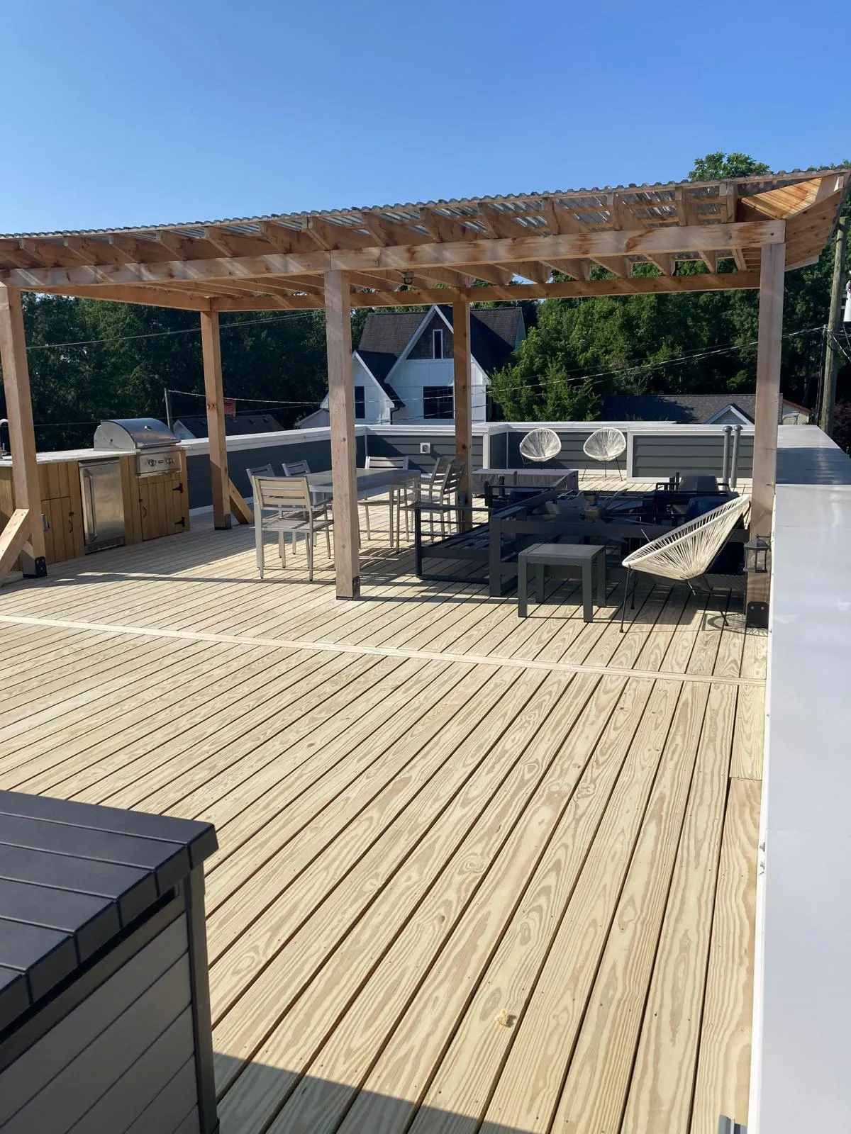 Wood deck with a pergola over an outdoor kitchen