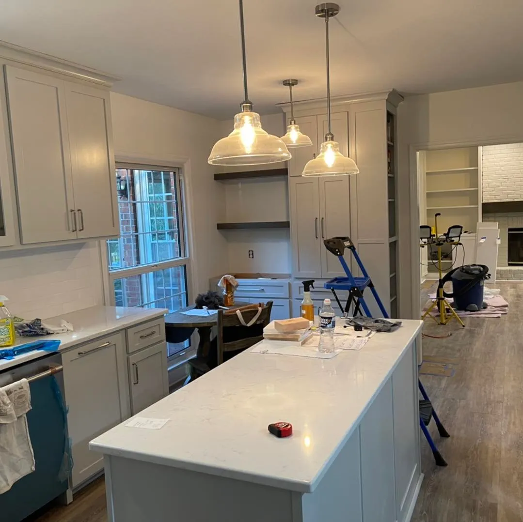 Remodeled kitchen with a center island and pendant lights
