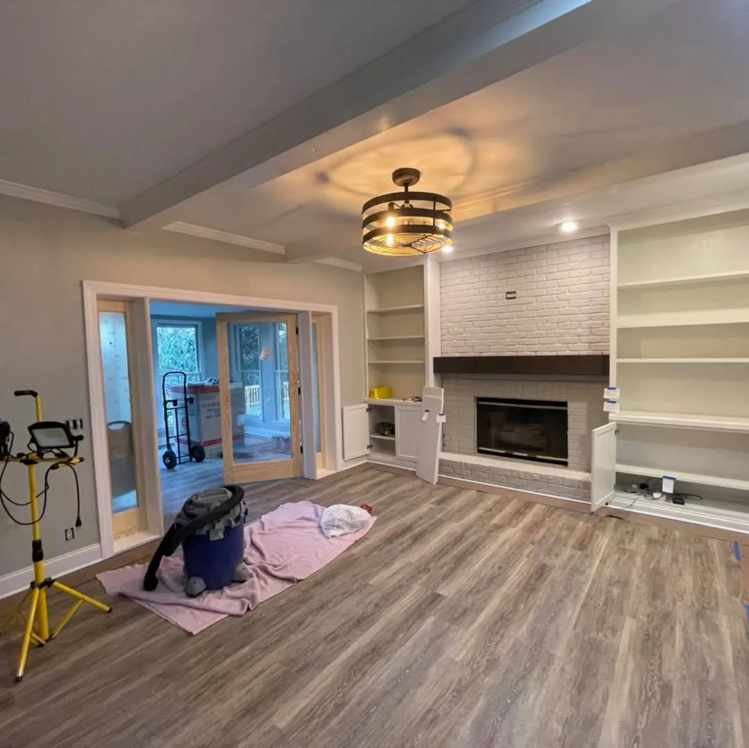 Living room built-ins over a wide-plank wood floor