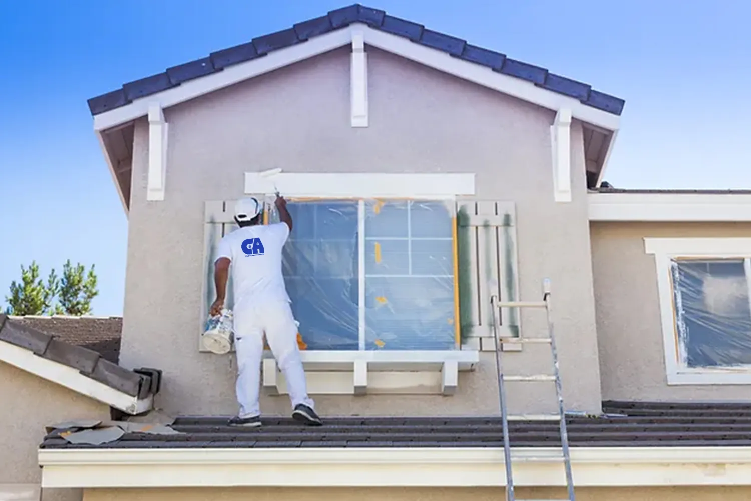 C&A painter on a ladder painting second-story exterior trim