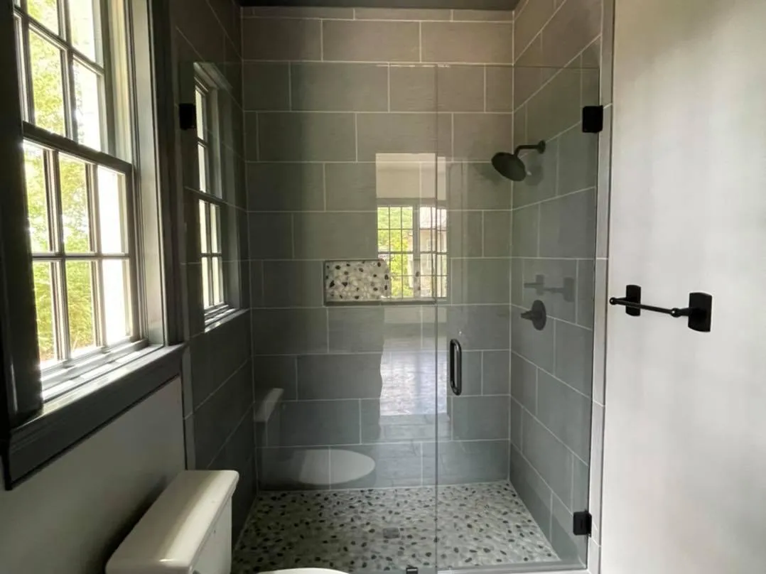 Walk-in tile shower with a frameless glass door